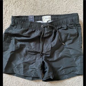 Black swim trunks, shorter.